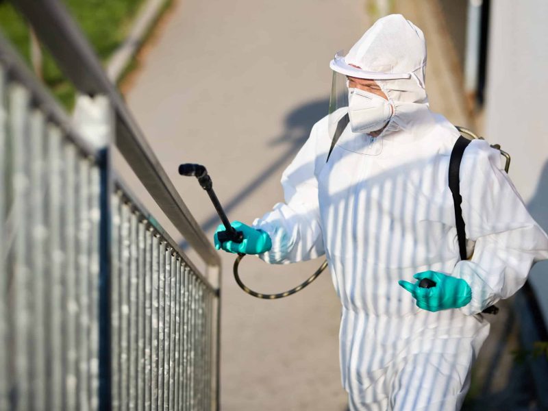Disinfectant worker sanitizing city area in order to prevent spread of coronavirus.